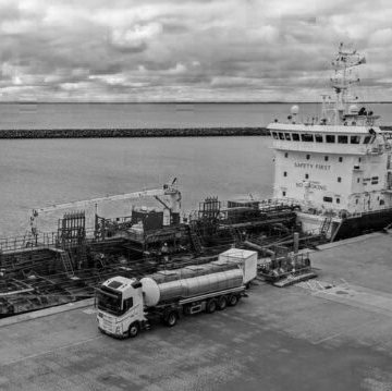 Tanker truck delivering to a vessel at port