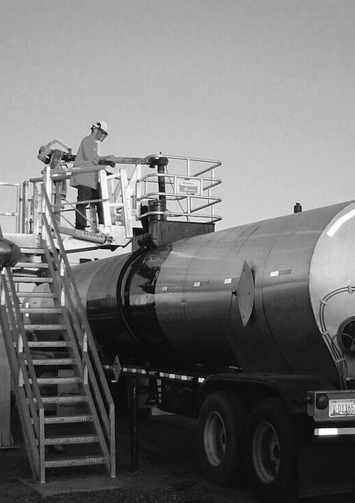 Technician performing tank truck loading at a fuel terminal